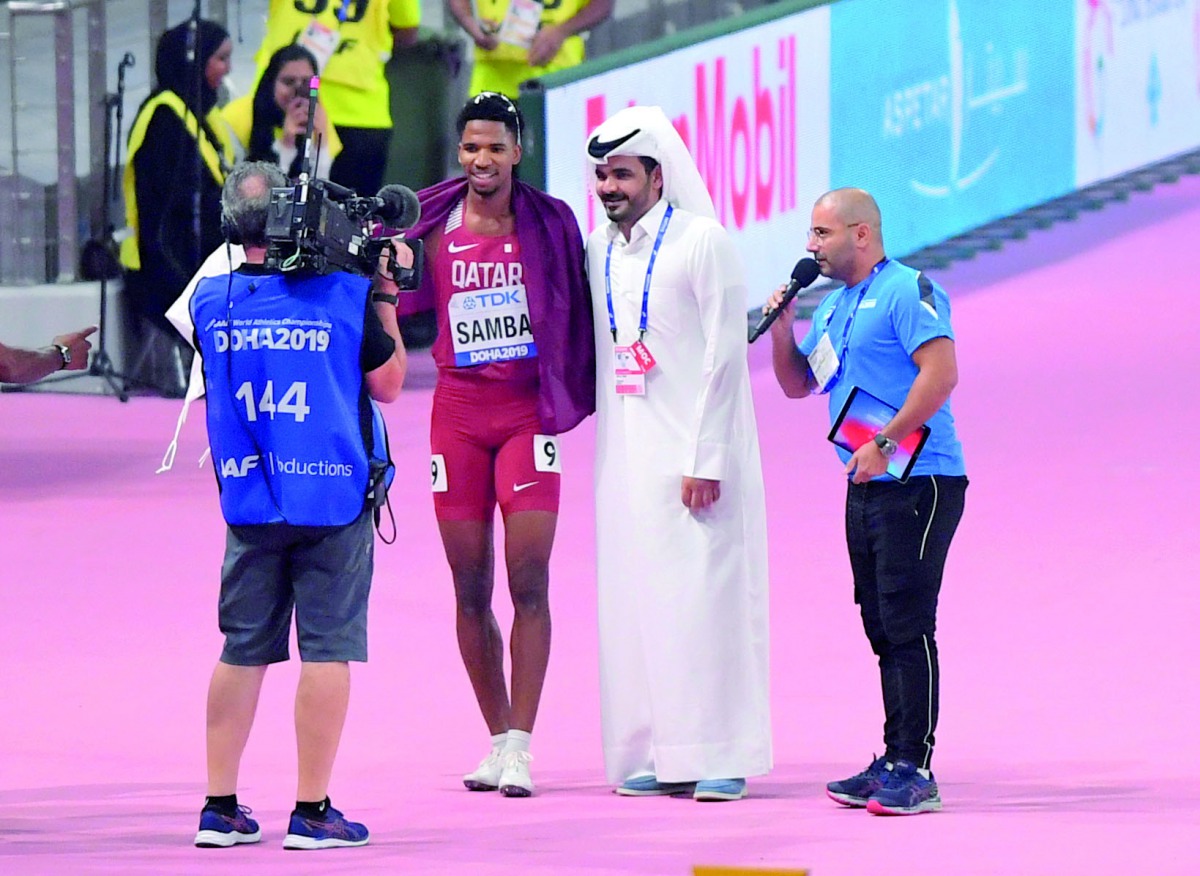 Abderrahman Samba with the Qatar Olympic Committee Chairman, H E Sheikh Joaan bin Hamad bin Khalifa Al Thani, after winning the hosts’ first medal at the IAAF Doha Worlds, yesterday. 
Pictures: Abdul basit / The Peninsula