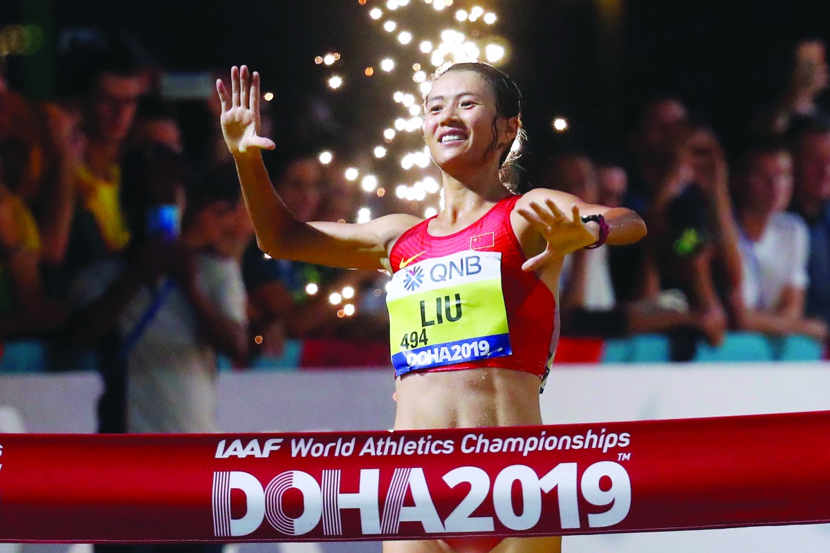 China’s Hong Liu crosses the finish line to win gold in the women’s 20 Kilometres race walk at the Corniche in Doha, yesterday.