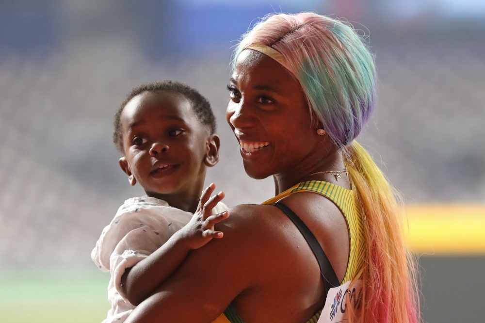 Jamaica's Shelly-Ann Fraser-Pryce celebrates after winning the Women's 100m final at the 2019 IAAF World Athletics Championships at the Khalifa International Stadium in Doha on September 29, 2019. / AFP / KARIM JAAFAR 