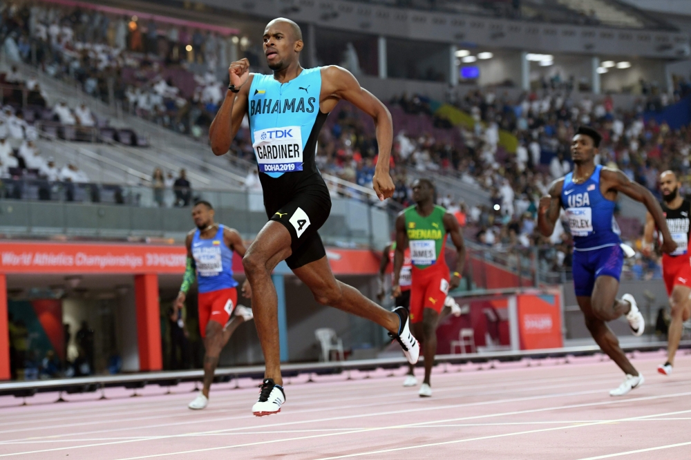 Bahamas' Steven Gardiner (front L) reacts as he crosses the finish line and wins in the Men's 400m final at the 2019 IAAF Athletics World Championships at the Khalifa International stadium in Doha on October 4, 2019. / AFP / Kirill KUDRYAVTSEV