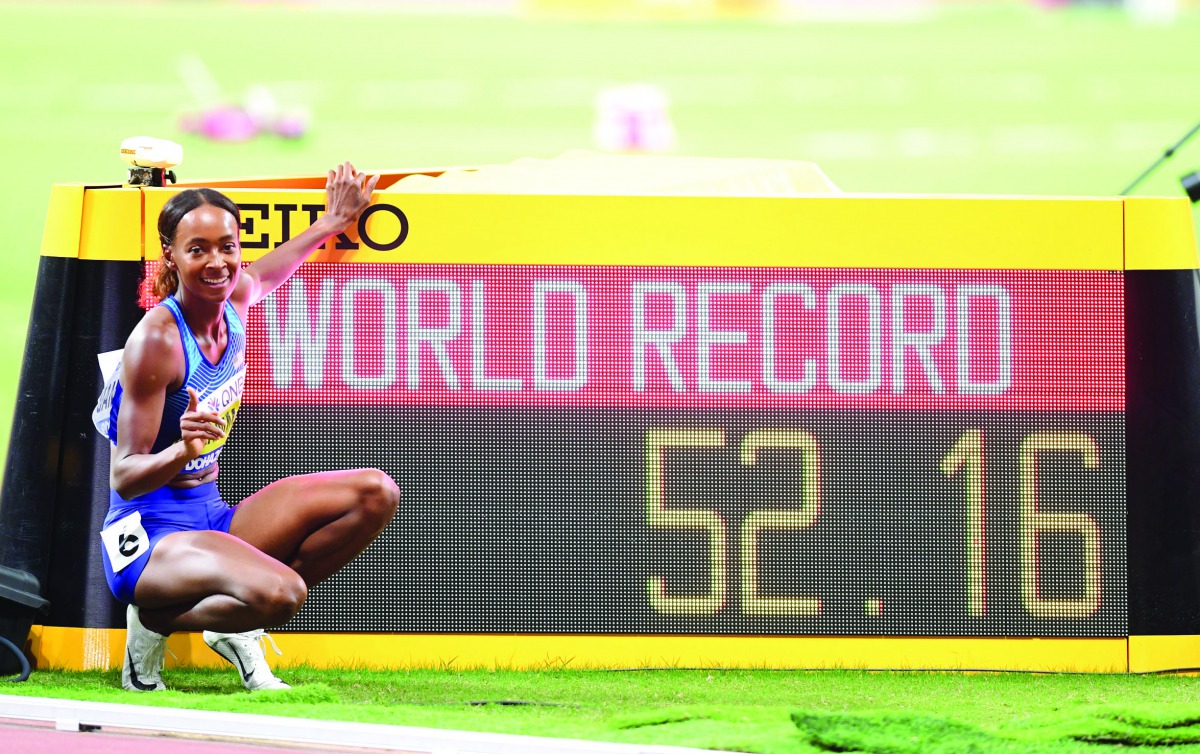 Dalilah Muhammad of the US poses next to the screen reading the new world record in the women’s 400m hurdles final at the 2019 IAAF Athletics World Championships at the Khalifa International stadium in Doha, yesterday. Pictures: Abdul Basit / The Peninsul