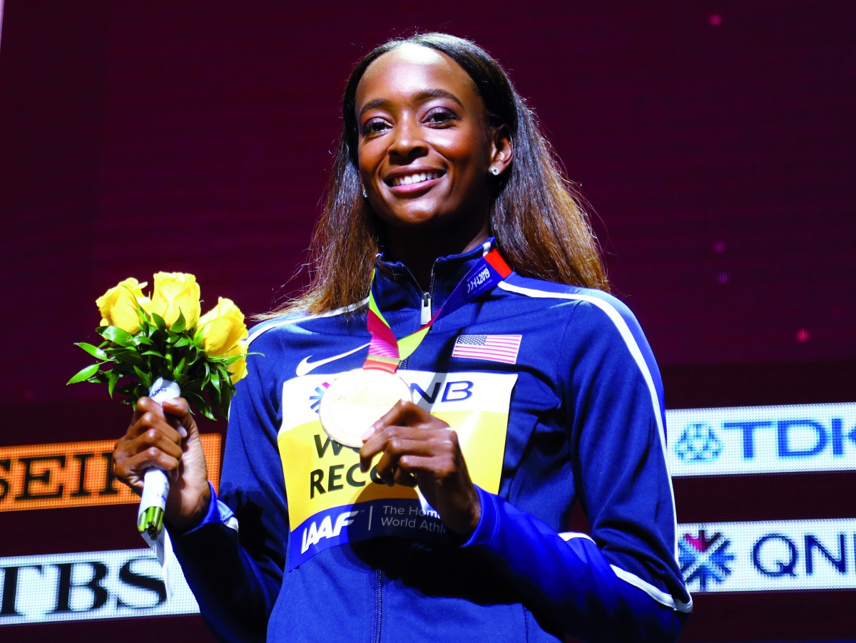 Dalilah Muhammad of the U.S. poses after winning gold and breaking the world record