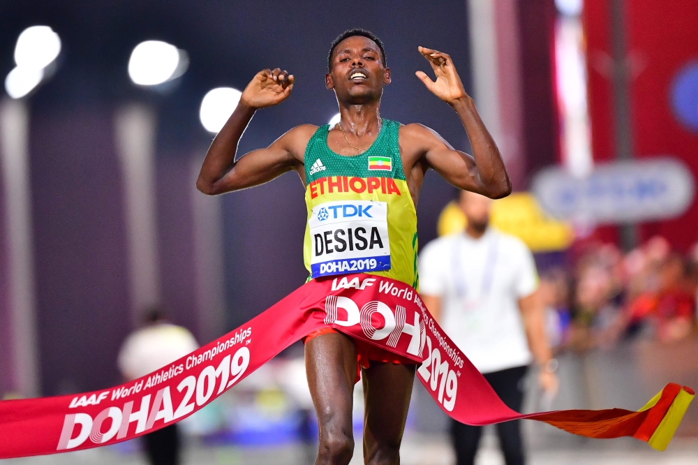 Ethiopia's Lelisa Desisa celebrates as he crosses the finish line and wins the Men's Marathon at the 2019 IAAF Athletics World Championships in Doha in the night between October 5, 2019 and October 6, 2019. / AFP / Giuseppe Cacace 