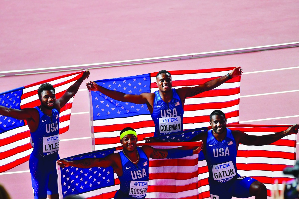 FROM LEFT: USA’s Noah Lyles, Michael Rodgers, Christian Coleman and Justin Gatlin pose with their national flag after winning the men’s 4x100m relay final at the IAAF World Athletics Championships Doha 2019 at the Khalifa International Stadium on Sunday. 