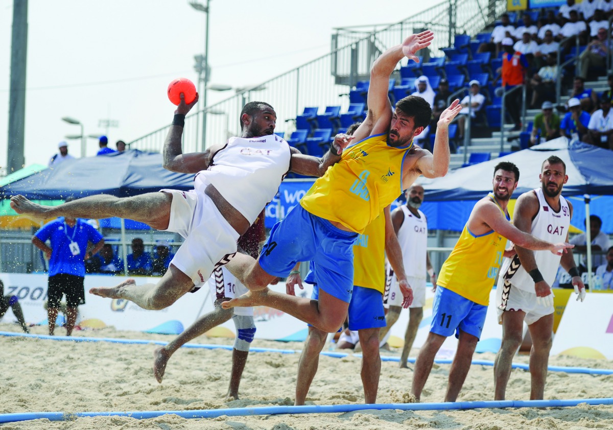 A Qatari player shoots to score against Uruguay during their beach handball match played  at Katara Beach, yesterday.Picture: Anvar Sadath