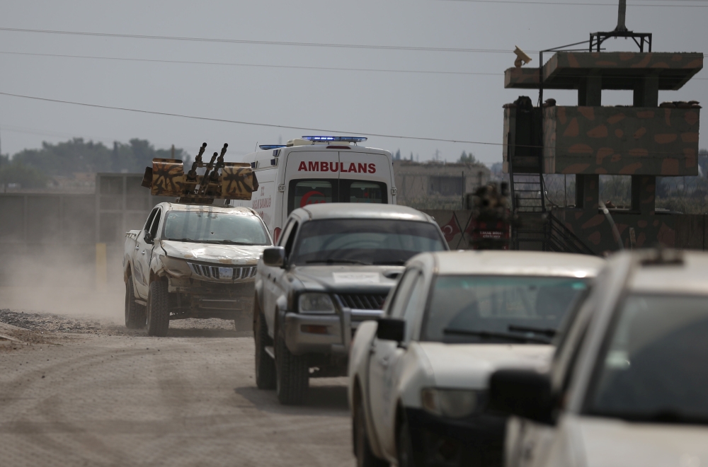 Turkey-backed Syrian rebel fighters return from the Syrian border town of Tal Abyad, as they are pictured on the Turkish-Syrian border in Akcakale, Turkey, October 19, 2019. REUTERS/Stoyan Nenov