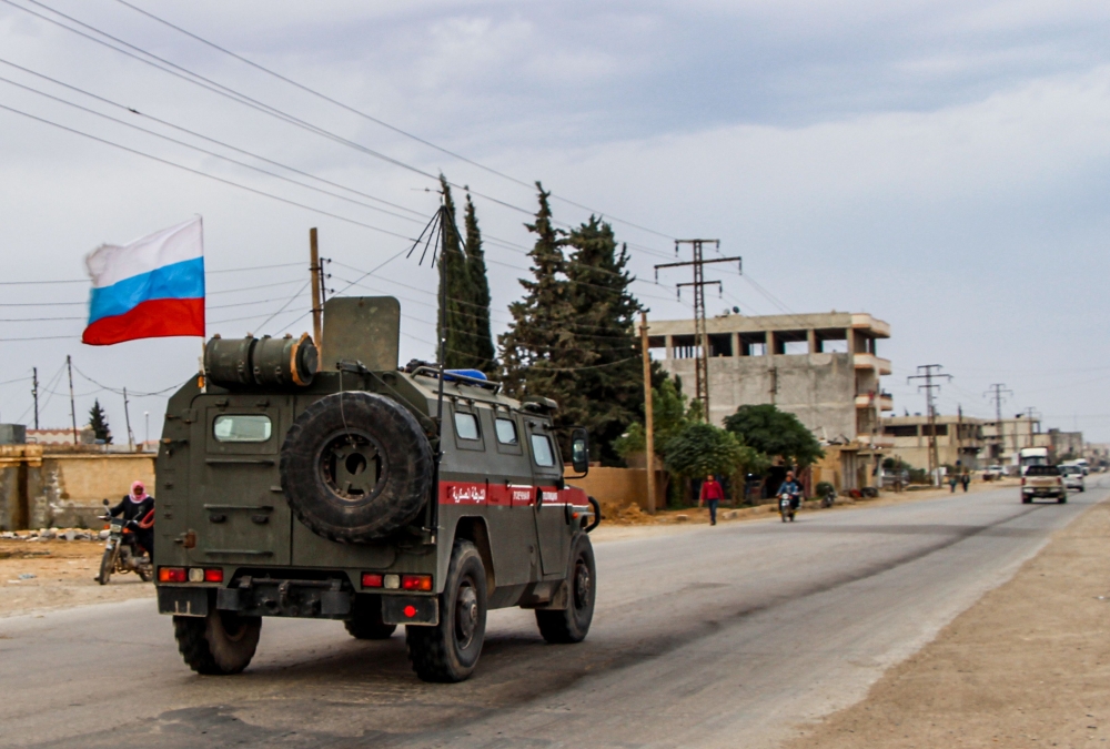 Russian military police vehicles drive in a joint patrol with the Syrian Kurdish Asayish internal security forces in the town of Kobane, also known as Ain al-Arab, in the north of Syria's Aleppo province on October 25, 2019. / AFP / -