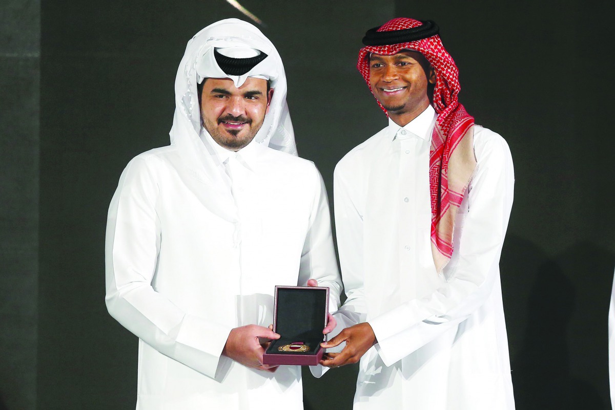 Qatar Olympic Committee President H E Sheikh Joaan bin Hamad Al Thani presenting the Male Player of the Year Award to high jump world champion Mutaz Essa Barshim during the annual Sports Excellence Awards held in Doha yesterday. Pictures: Mohamed Farag