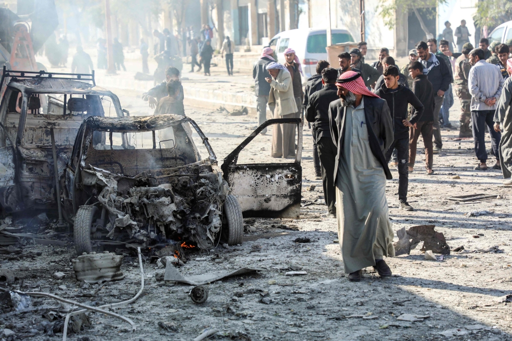 The aftermath of a car bomb explosion at the industrial zone in the northern Syrian town of Tal Abyad, on the border with Turkey.   AFP / Zein Al RIFAI