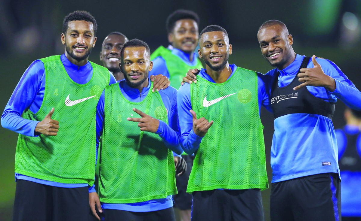 Almahdi Ali Mukhtar (left) and his Qatri team-mates gesture during a training session at Aspire zone in Doha.