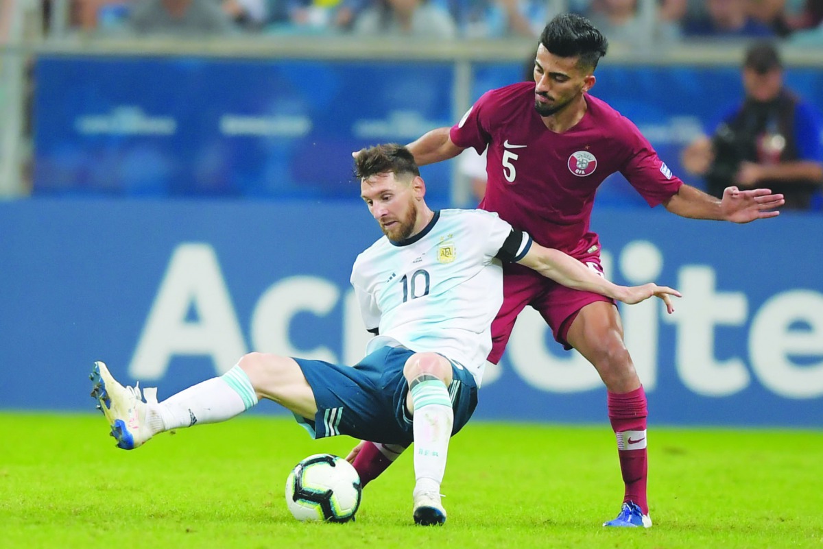 Argentina’s Lionel Messi (left) and Qatar’s Tarek Salman in action during their Copa America Group B match played at the Gremio Arena in Porto Alegre, Brazil, in this June 23 file photo.