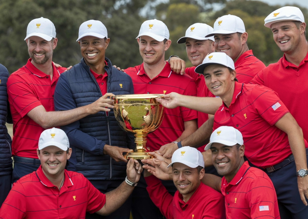 US team captain Tiger Woods (top row, 2nd L) and his teammates pose with the Presidents Cup after their win over the International Team on the final day of the Presidents Cup golf tournament in Melbourne on December 15, 2019. AFP / Simon Baker 