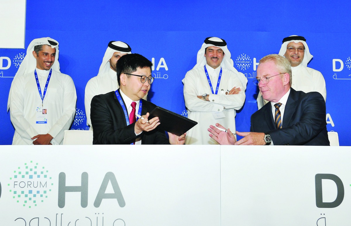 Minister of State and Chairman of Qatar Free Zones Authority (QFZA), H E Ahmad bin Mohammed Al Sayed (second right, back), witnessing the signing ceremony which was facilitated by Lim Me Hui (front, left), CEO of QFZA, and Deesch Papke (front, right), Gro