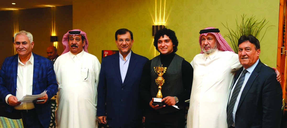 Qatari weightlifter Fares Ibrahim Hassouna  (third right) posing for a photograph with the President of the Qatar weightlifting and Fencing Federation, Arab and Asian Weightlifting Federations, Mohamed Yousef Al Mana (second right) during the closing cere