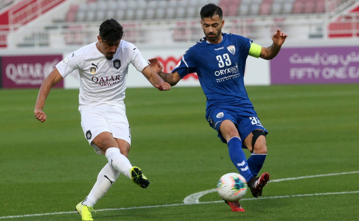 Al Sadd SC's Algerian striker Baghdad Bounedjah shoots to score while Al Kharaitiyat skipper Pejman Mohammadreza tries to spoil his effort during their Amir Cup Round of 16 match played at the Abdullah Bin Khalifa Stadium in Doha, yesterday. Pictures: Hus