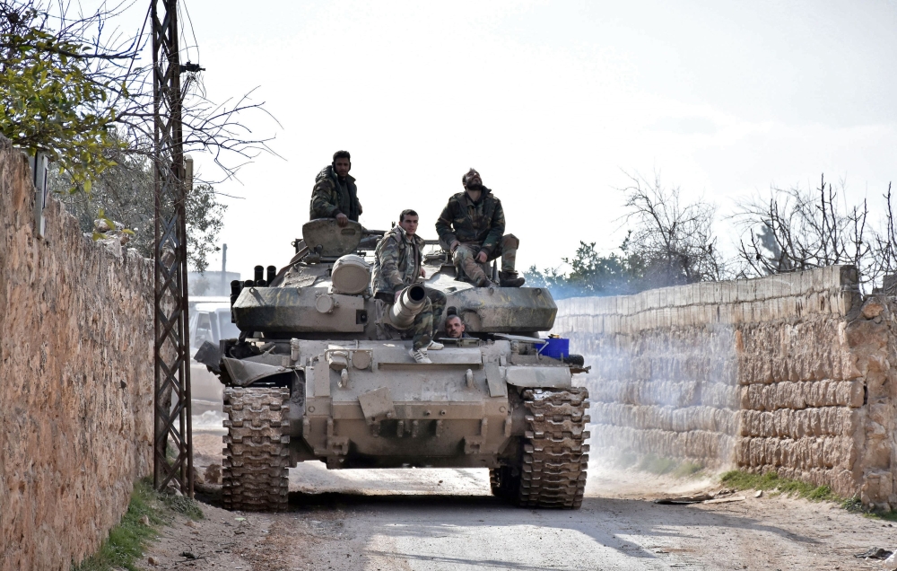 Syrian troops gathering in an area southwest of Saraqeb during their assault on Idlib region. AFP 