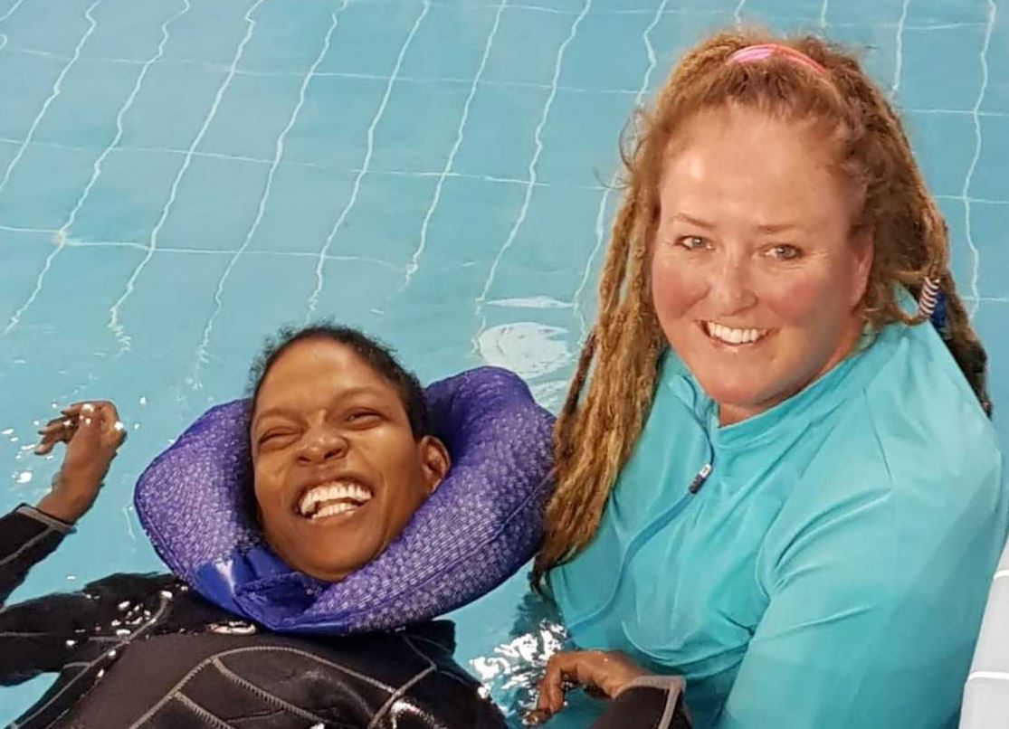 Kathleen Bates, Senior Autism Spectrum Disorder and Special Needs Aquatics Specialist and Coach at Qatar Foundation, with one of the participants in the Ability-Friendly Swimming Program.