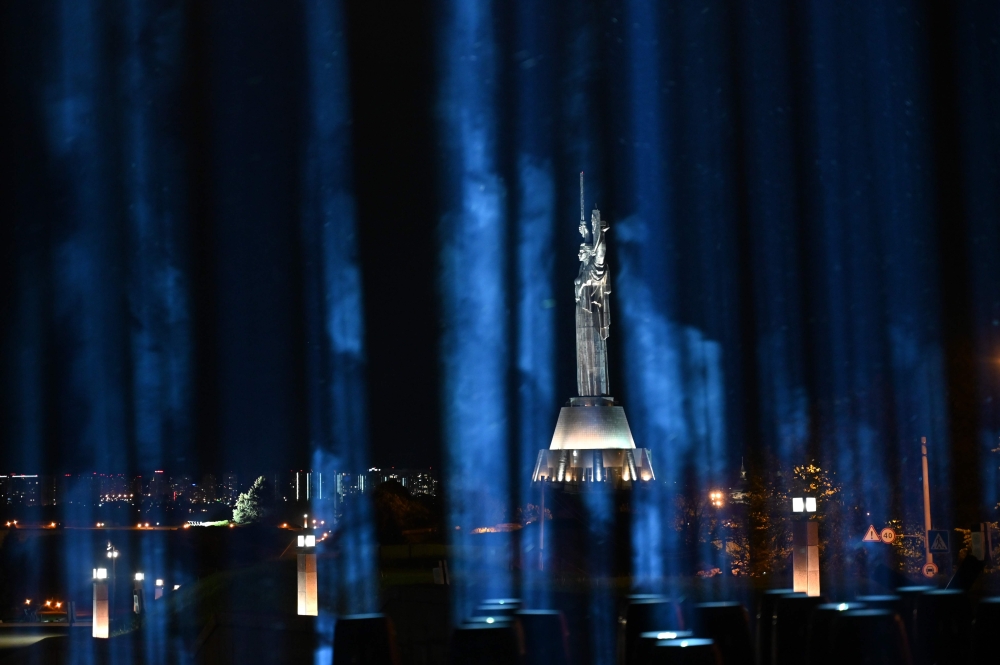 This picture shows the Motherland monument lit up in the Ukrainian capital of Kiev during the lighting protest 