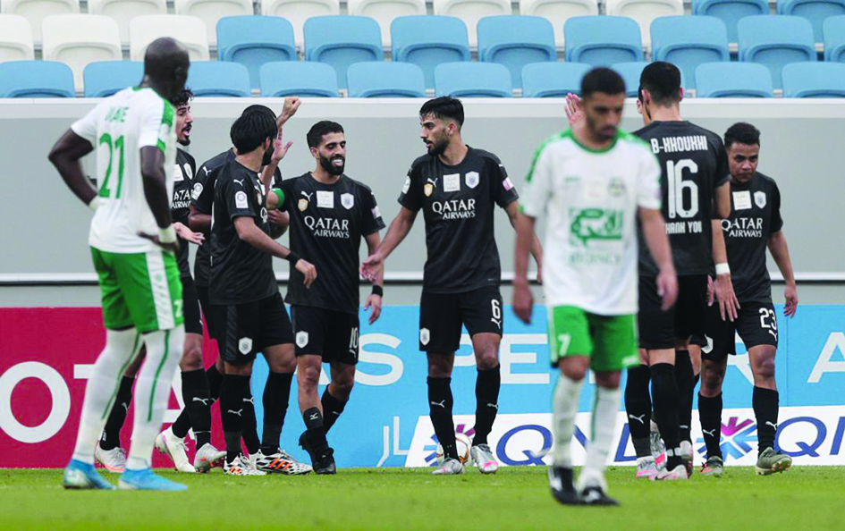 Al Sadd's Hassan Al Haydos (centre) is congratulated by team-mates after he scored a goal against Al Ahli.