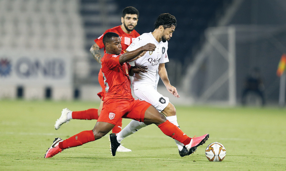 Al Sadd's Rodrigo Tabata (right) and Al Duhail's Assim Madibo in action during yesterday's QNB Stars League match at Al Sadd Stadium.