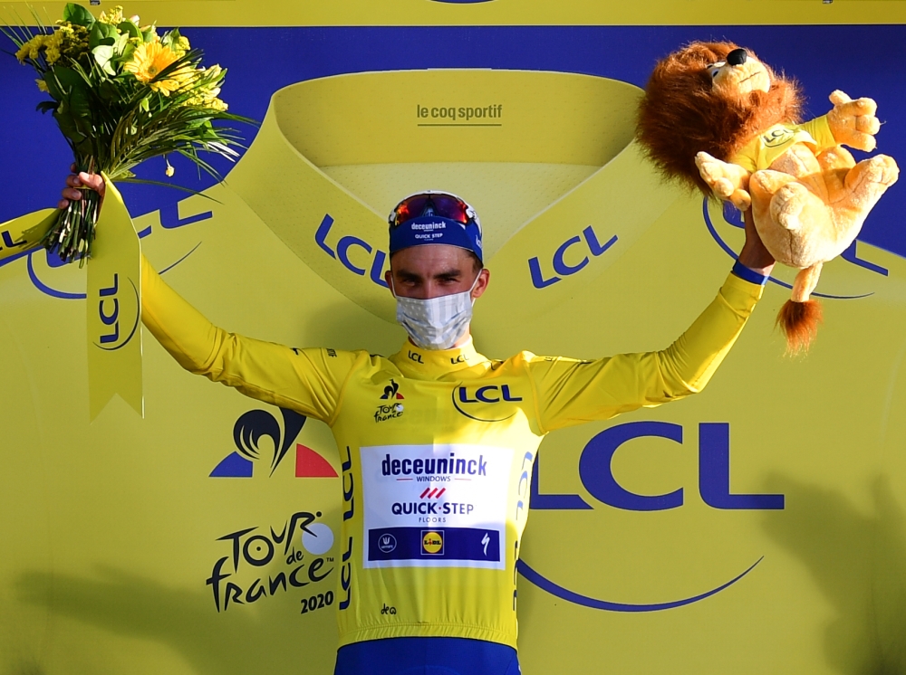 Stage winner Team Deceuninck rider France's Julian Alaphilippe celebrates his overall leader yellow jersey on the podium after winning the 2nd stage of the 107th edition of the Tour de France cycling race, 187 km between Nice and Nice, on August 30, 2020.