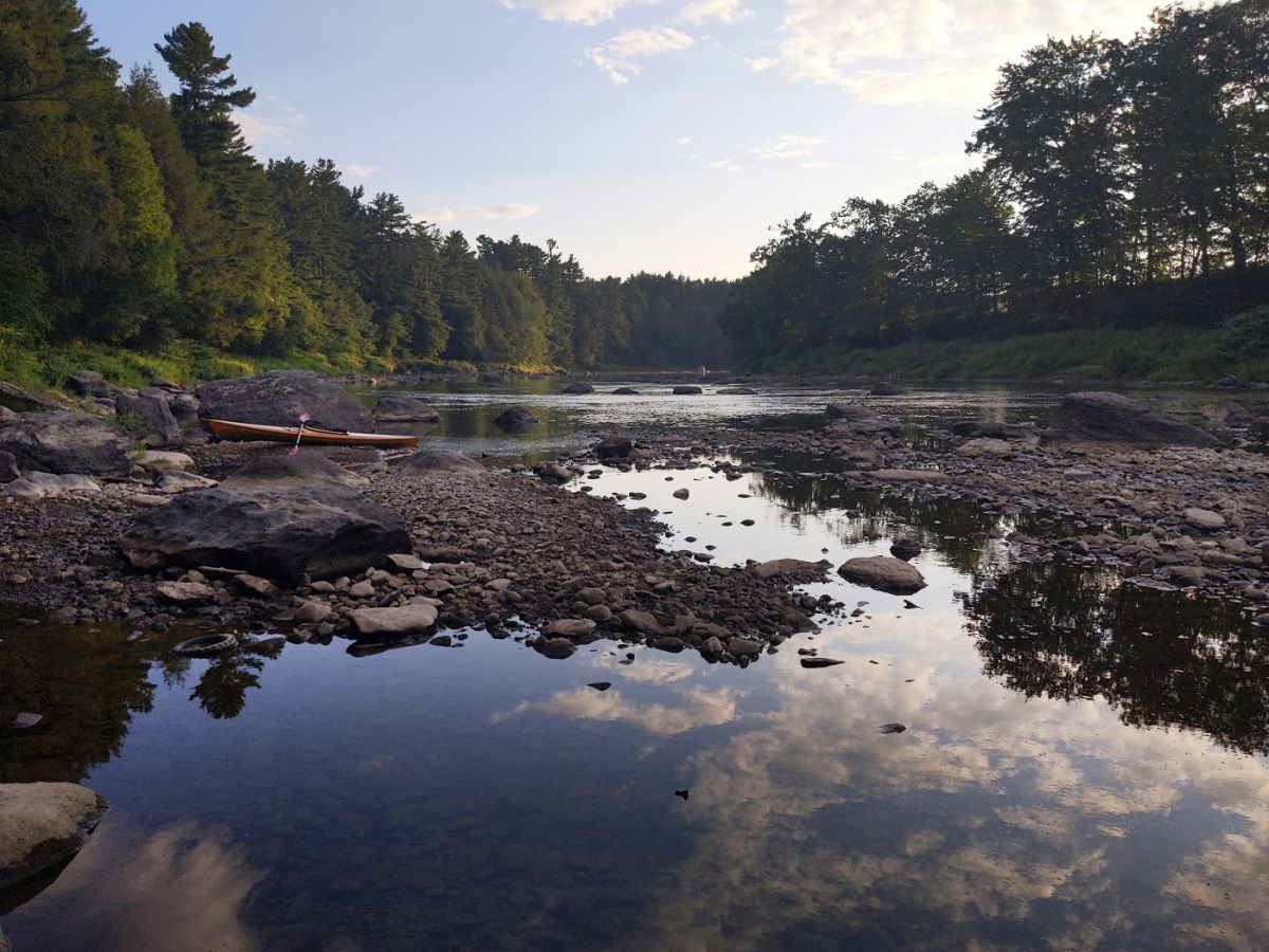 Sunset at Lussier Campsite on the Missisquoi River. Low water exposes rocky shoals along the water's edge. Photo for The Washington Post by Jen Rose Smith