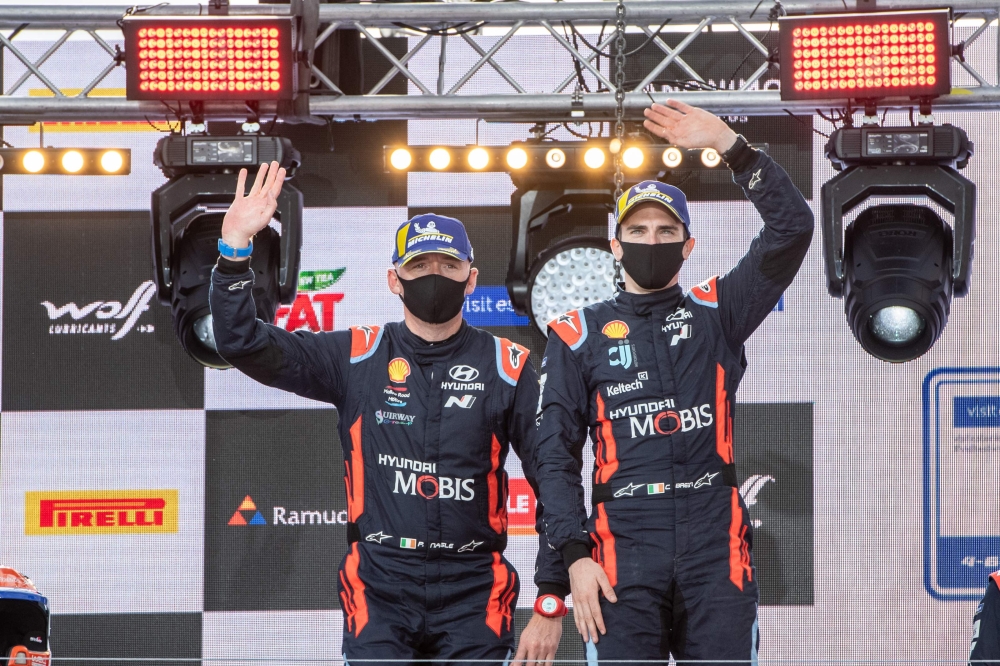 First placed (C) driver Ott Tanak of Estonia and his co-driver Martin Jarveoja of Estonia celebrate on the podium after the Rally Estonia on September 6, 2020 in Tartu, south Estonia. / AFP / RAIGO PAJULA