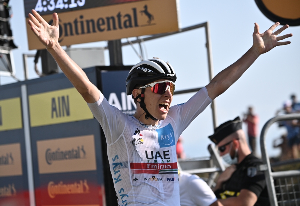  UAE Team Emirates rider Tadej Pogacar of Slovenia, wearing the white jersey for best young rider, crosses the finish line to win the stage Pool via REUTERS/Anne-Christine Poujoulat