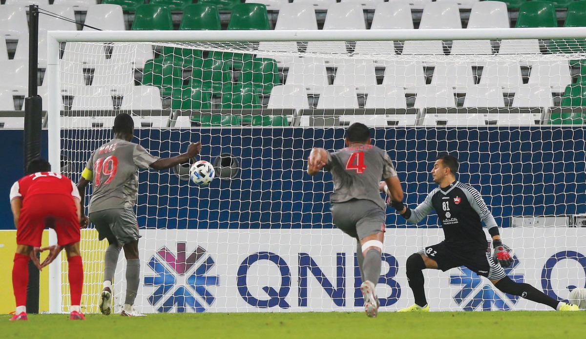 Al Duhail’s forward Almoez Ali (left) scores from a penalty spot against Iran’s Persepolis,  yesterday. 