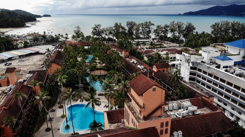 This aerial photo taken on October 1, 2020 shows empty swimming pools at a hotel on Patong beach in Phuket. AFP / Lillian Suwanrumpha 