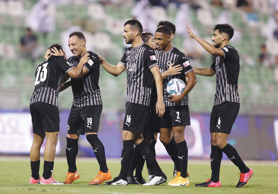 Al Sadd's players celebrate with Hashim Ali (left). 