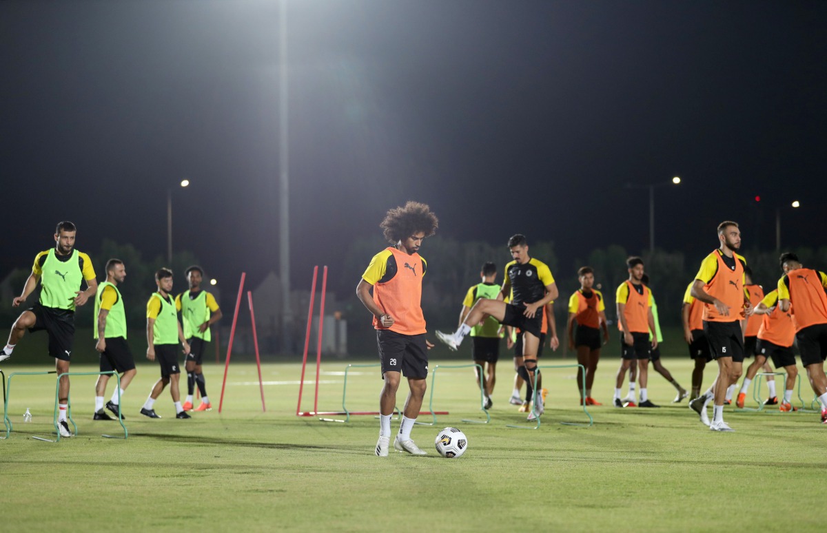 Al Sadd's Akram Afif with team-mates during a practice session on the eve of their Amir Cup semi-final against Al Duhail. Bottom: Al Duhail players during a practice session.