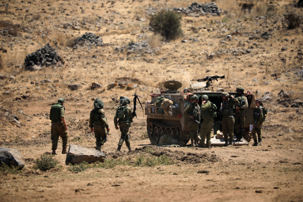 Israeli soldiers walk during a drill in the Israeli-controlled Golan Heights near the Israel-Syria frontier in August. Amir Cohen/Reuters