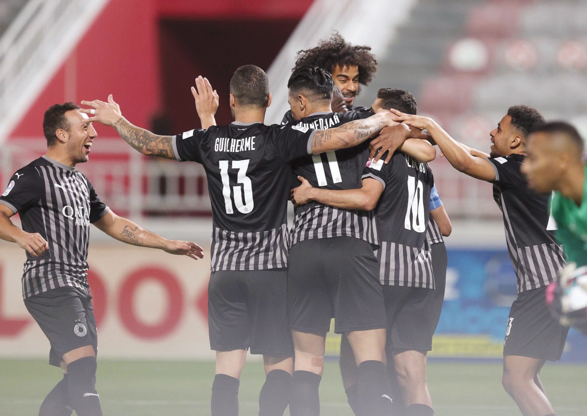 Al Sadd's players celebrate the goal scored by Abdelkarim Hassan.