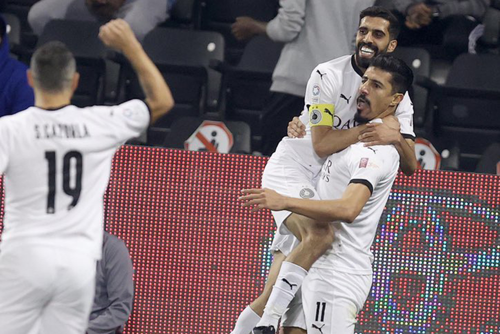 Al Sadd's Baghdad Bounedjah celebrates with captain Hassan Al Haydos after completing a hat-trick against Al Duhail in yesterday's match. 