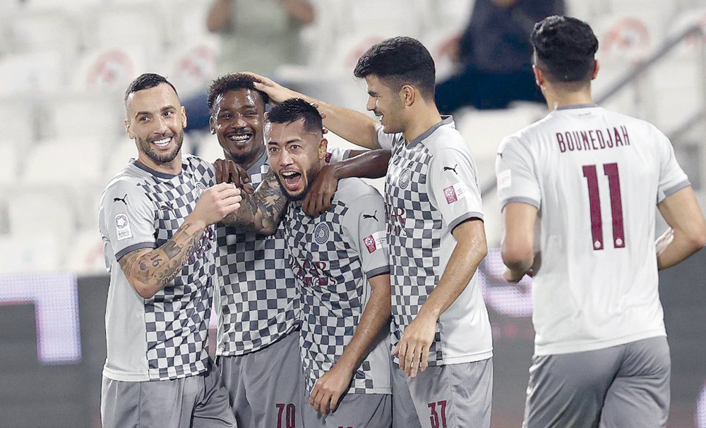 Al Sadd players congratulate team-mate Rodrigo Tabata after the latter completed his hat-trick against Al Khor yesterday.