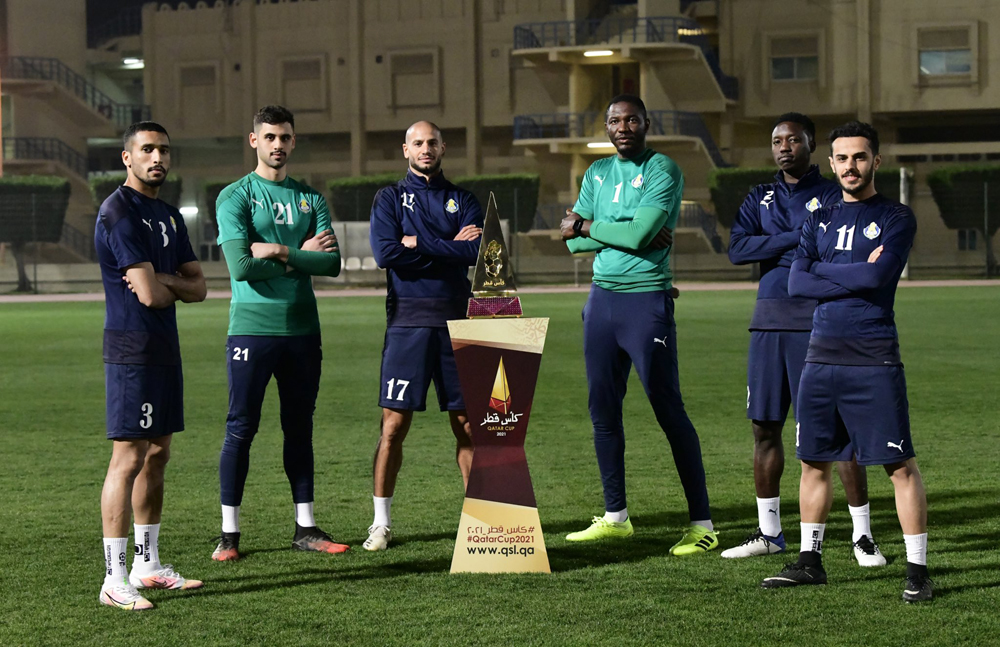 Al Gharafa players with the Qatar Cup winners trophy.