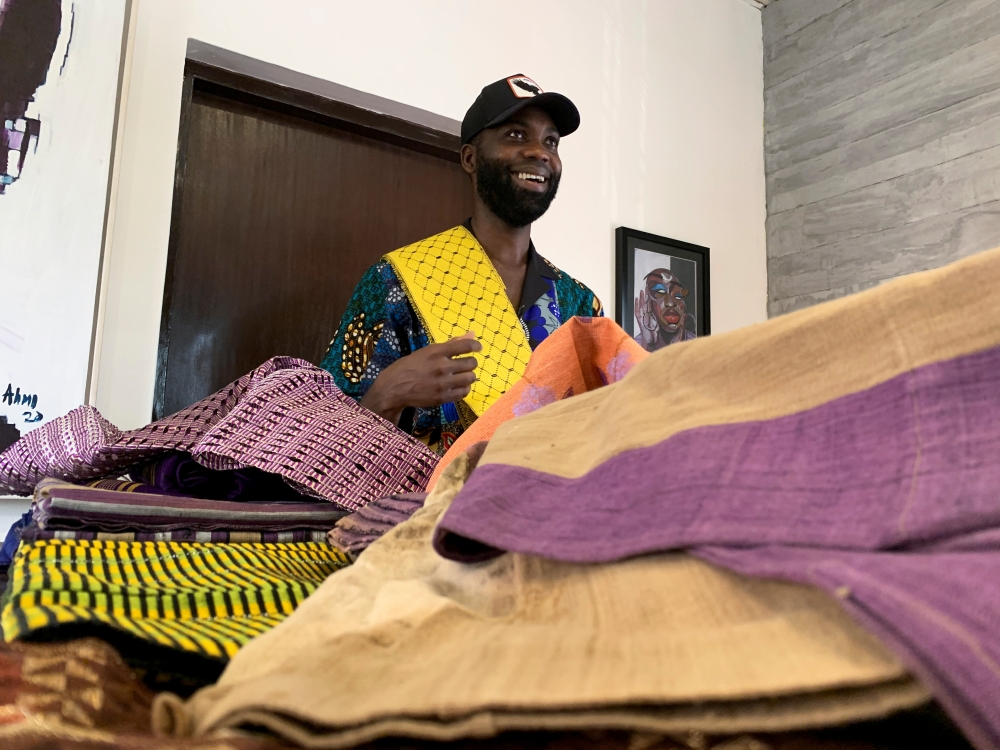 Fashion designer Tsemaye Binitie holds his custom Aso-Oke fabric during a workshop in Lagos, Nigeria February 8, 2021. Picture taken February 8, 2021. REUTERS/Nneka Chile