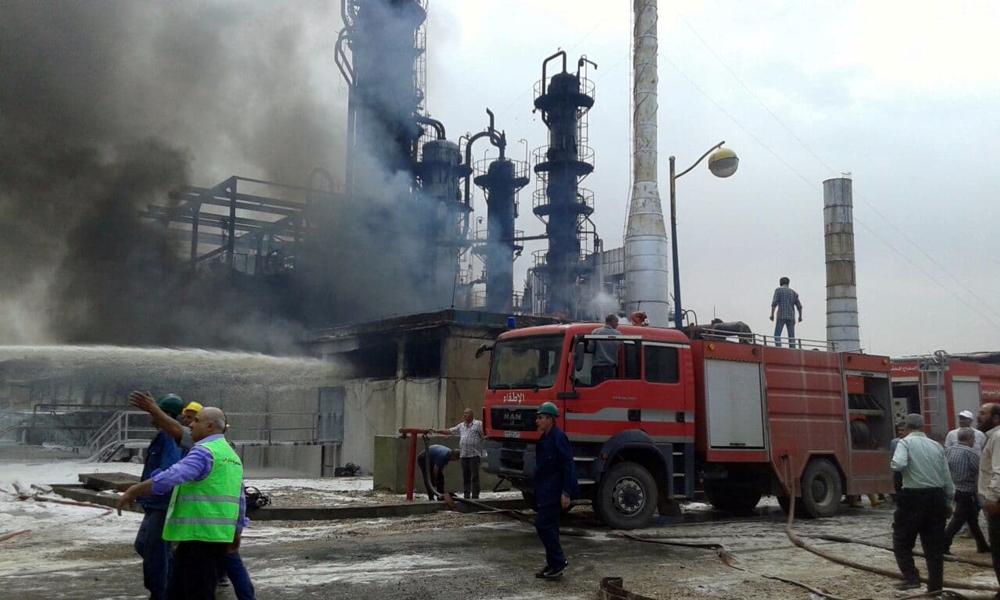 Firefighters try to put out a fire in main Homs refinery, Syria, in this handout picture released on May 9, 2021. 