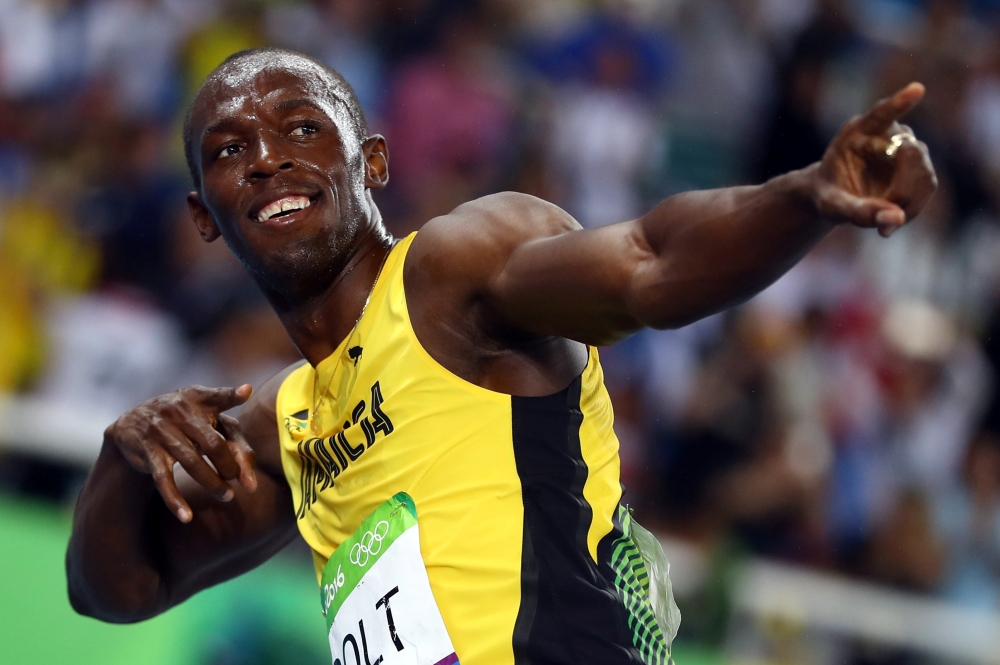Usain Bolt (JAM) of Jamaica celebrates after winning gold. REUTERS/Kai Pfaffenbach
