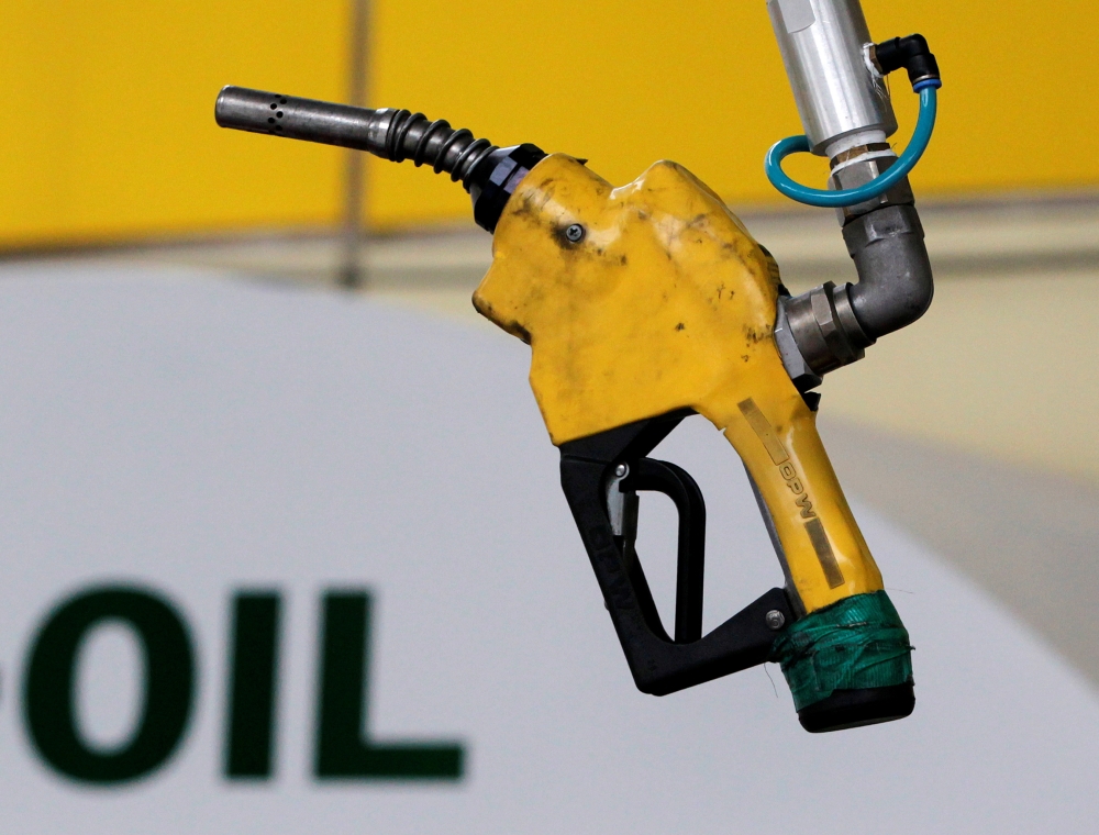 A gas pump is seen hanging from the ceiling at a petrol station in Seoul June 27, 2011. (REUTERS/Jo Yong-Hak/File Photo)