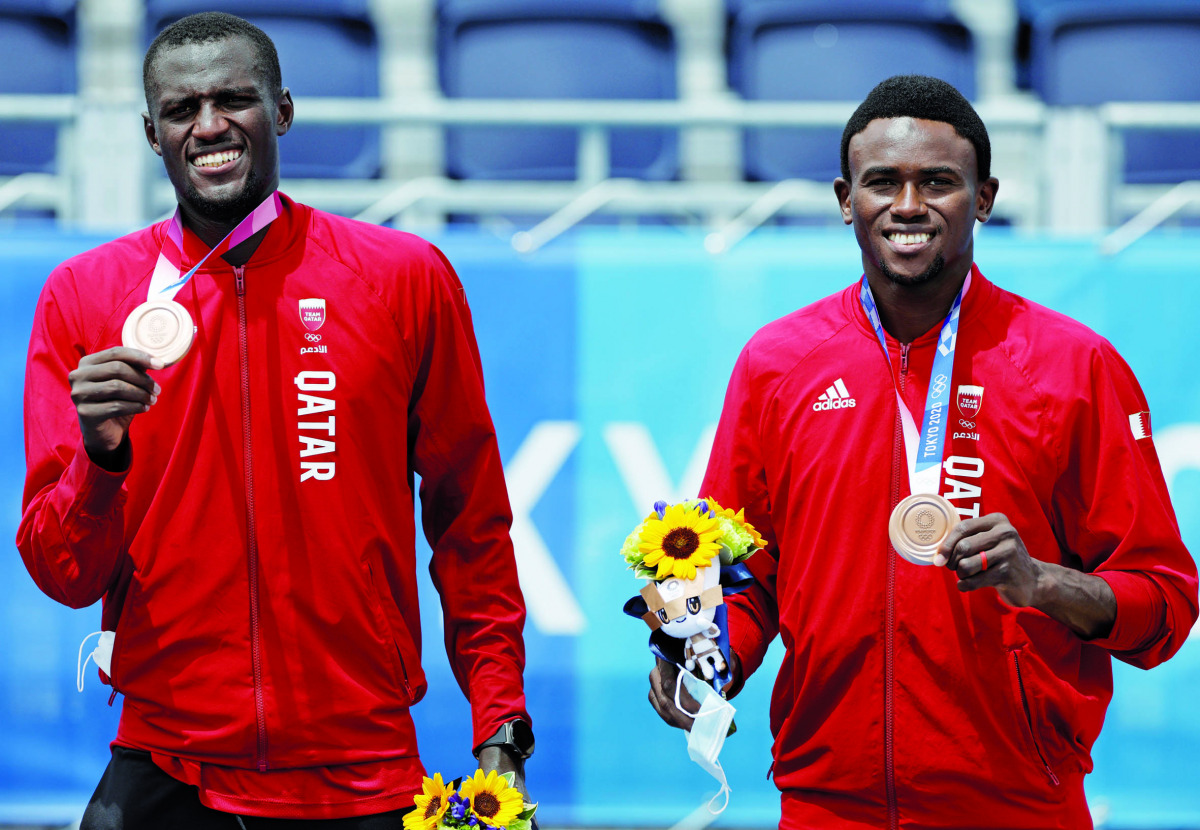 Cherif Younousse and Ahmed Tijan pose for photographs with their bronze medals.