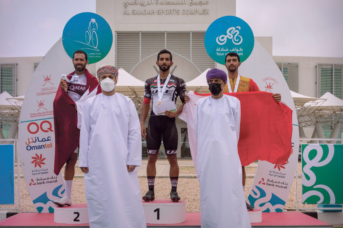 The podium winners of the fourth and final stage of the Tour of Salalah with officials during the presentation ceremony.