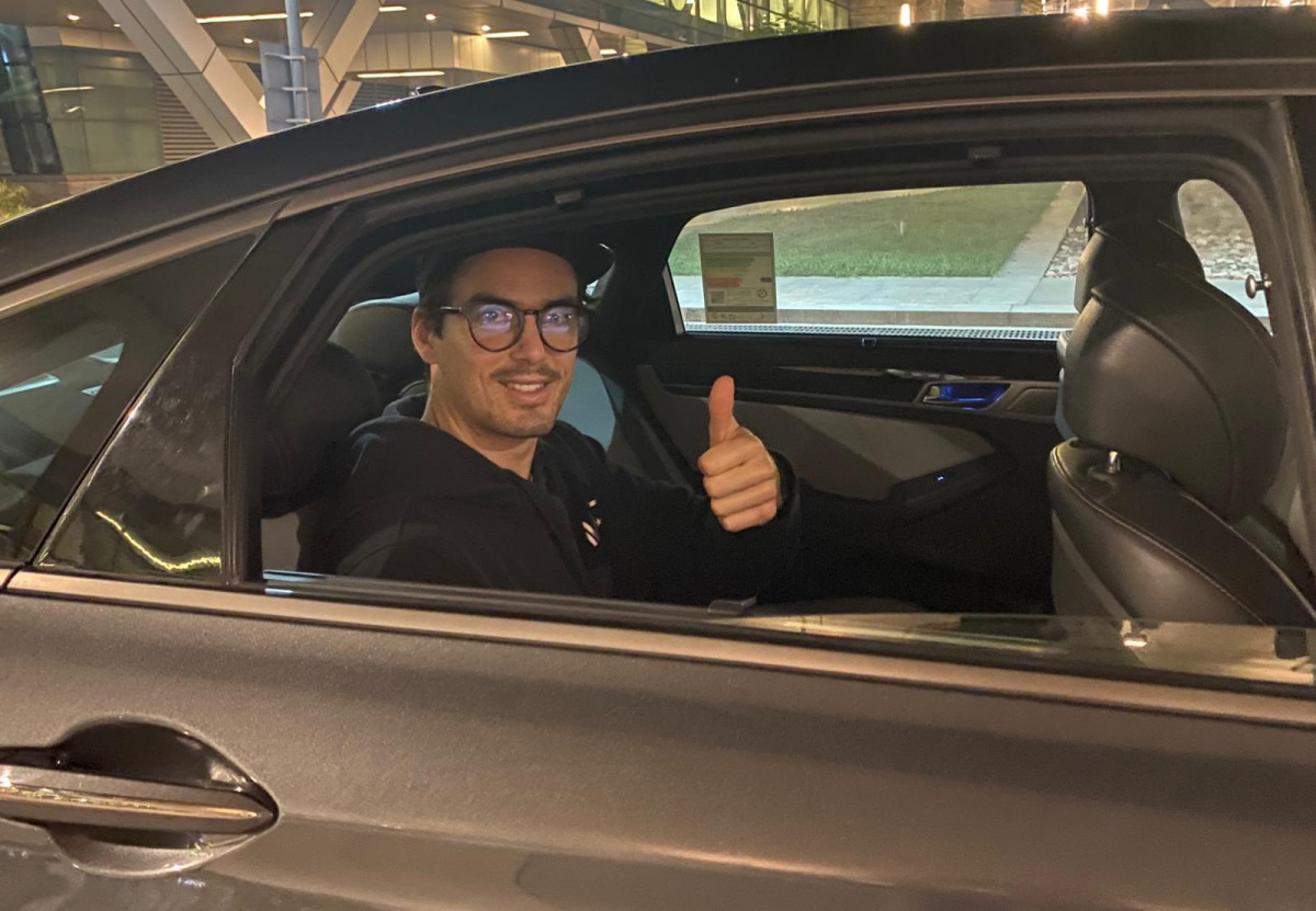 British Open champion Paul Coll gestures upon his arrival in Doha. 