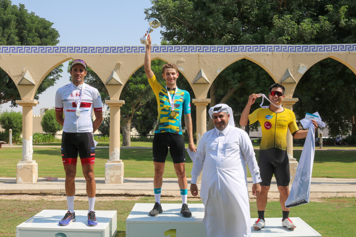 Bilal Al Saadi of Rasen Adventure Shop celebrates with other podium winners and an official after winning Race A.