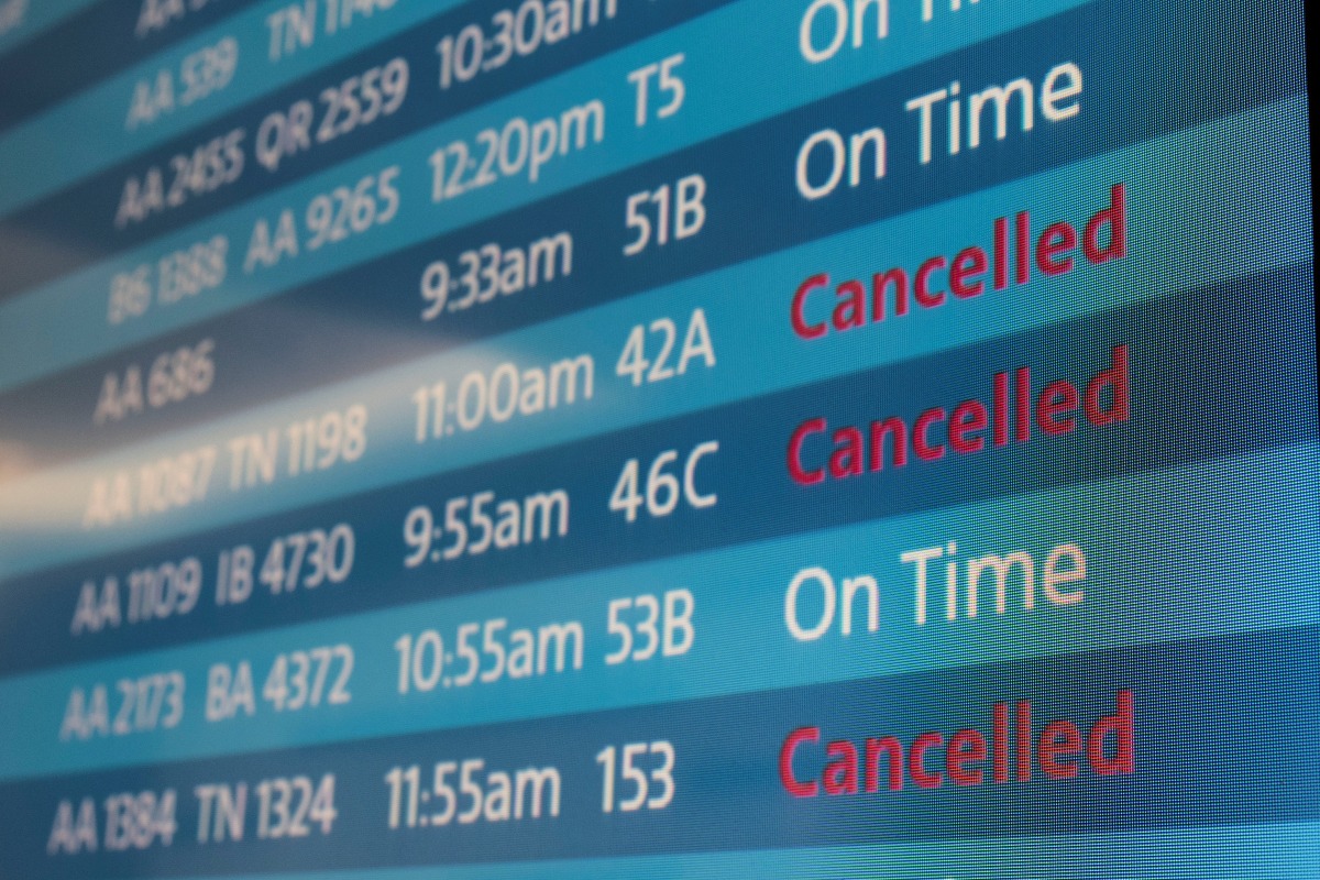 A screen showing cancelled flights is seen at Los Angeles International Airport as more than 1,400 American Airlines flights over the weekend have been canceled due to staff shortages and unfavorable weather in Los Angeles, California, U.S., October 31, 2021. REUTERS/Carlos Barria
