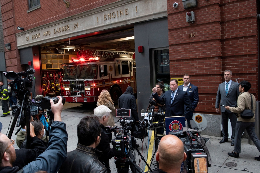 :FILE PHOTO: New York City Fire Department (FDNY) Uniformed Firefighters Association (UFA) President Andrew Ansbro speaks while a NYFD truck exit the building during a news conference as the city's COVID-19 vaccine mandate deadline approaches at Ladder Co. 24 in Manhattan, New York City, New York, U.S., October 29, 2021. REUTERS/Eduardo Munoz/File Photo
