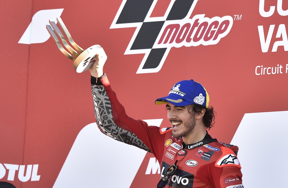 Ducati Lenovo Team's Francesco Bagnaia celebrates on the podium with the trophy after winning the race REUTERS/Pablo Morano