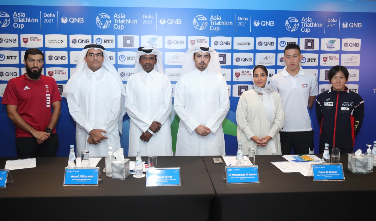 FROM LEFT: Qatari triathlete Fahad Al Muhammad, General Manager of QNB Group Communications Yousef Ali Darwish, Qatar Triathlon Federation (QTF) Secretary General Thani Al Zarraa, QTF President Dr Mohammed Al Kuwari, QTF board member Fatima Al Ghanim and triathletes Tuan Chun Chang of Chinese Taipei and Juri Ide of Japan pose for a photograph following a press conference held in Doha, yesterday.