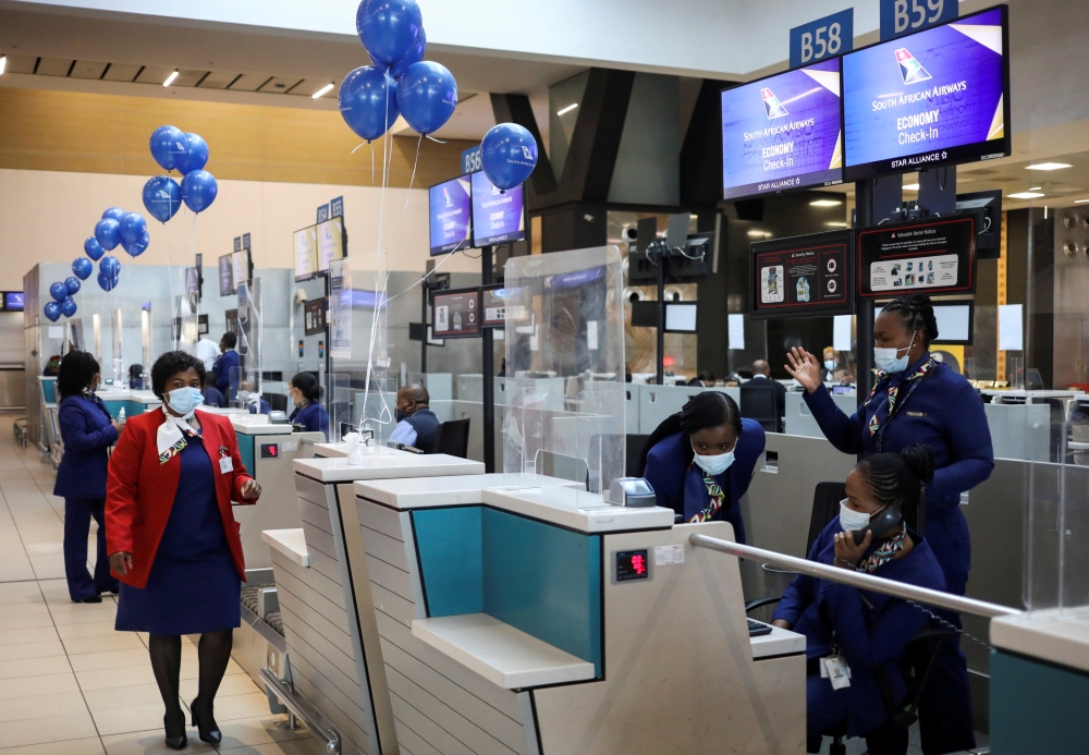 Workers prepare ahead of South Africa's national airline, South African Airways (SAA), taking off after a year-long hiatus triggered by it running out of funds, at O.R. Tambo International Airport in Johannesburg, South Africa, September 23, 2021. REUTERS/Siphiwe Sibeko/